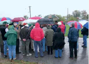 A gathering of umbrellas braved the elements to stand on the site of Camp Dick Robinson.